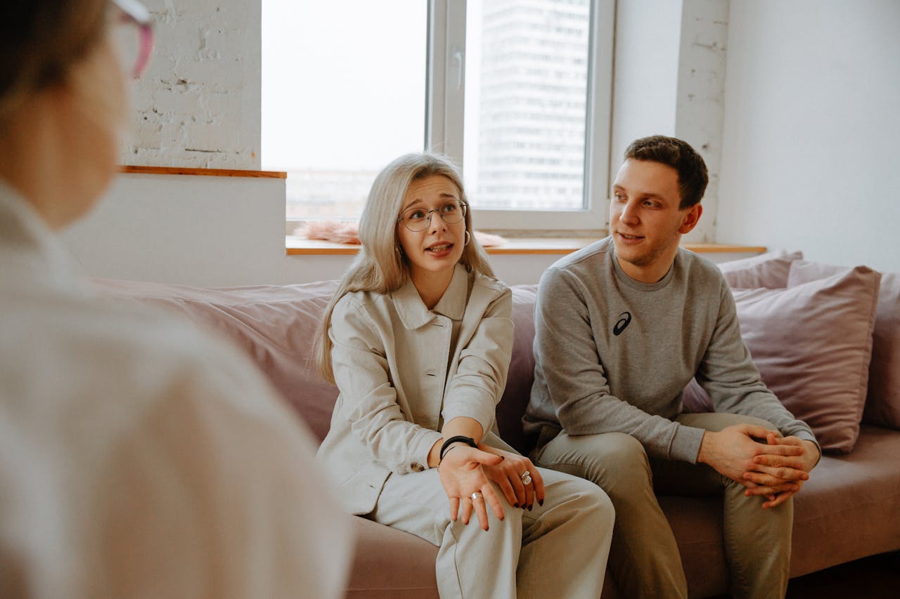 Couple engaged in a supportive discussion during a therapy session